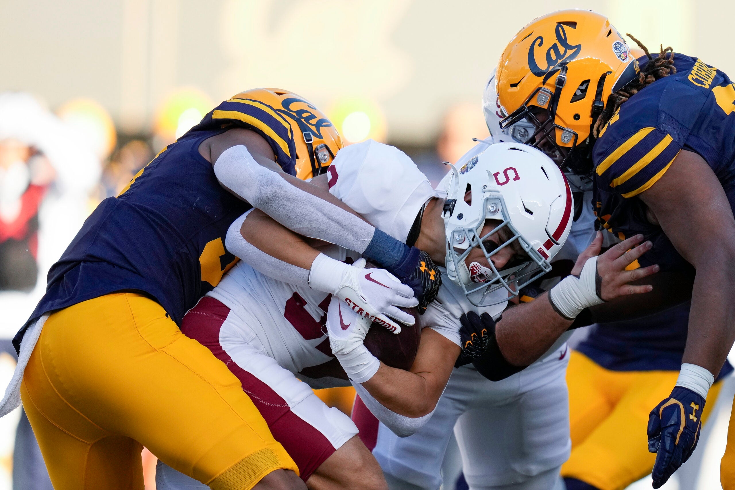 Stanford running back Mitch Leigber, middle, runs the ball against California.