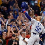 Los Angeles Dodgers' Mookie Betts tips his helmet as he comes up to bat against the Boston Red Sox during the first inning of a baseball game Friday, Aug. 25, 2023, in Boston.