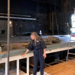 Susanna Gellert, executive artistic director for the Weston Theater Company, points to the level of the flooding in the Weston Playhouse.