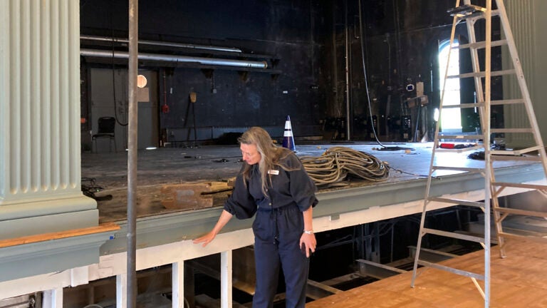Susanna Gellert, executive artistic director for the Weston Theater Company, points to the level of the flooding in the Weston Playhouse.