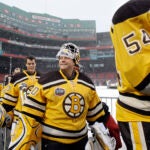 Boston Bruins players including goalie Tim Thomas, center, walk to the ice rink to practice at Fenway Park in Boston on Dec. 31, 2009, in preparation for New Years Day's Winter Classic NHL hockey game against the Philadelphia Flyers.