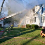 Firefighters battle a house fire on Herrick Road in North Andover, Mass.