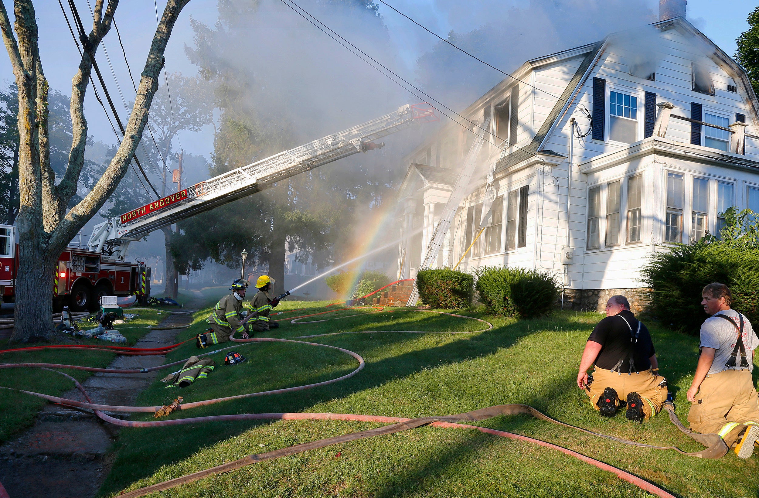 Firefighters battle a house fire on Herrick Road in North Andover, Mass.