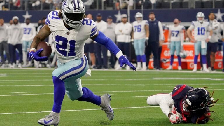 Ezekiel Elliott #21 of the Dallas Cowboys runs with the ball in the fourth quarter a game against the Houston Texans at AT&T Stadium on December 11, 2022 in Arlington, Texas.