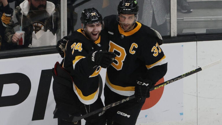 Boston Bruins Jake DeBrusk (L) celebrates his goal against the Ottawa Senators Goalie with teammate Patrice Bergeron during the first period of play at TD Garden.