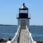 The Marshall Point lighthouse sits on the water's edge with its damaged light removed after a July 27 lightning strike Wednesday, Aug. 2, 2023, in the village of Port Clyde, Maine.