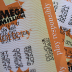 Several orange Mega Millions lottery tickets are pictured.