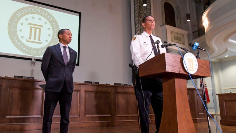 Montgomery Mayor Steven Reed, left, listens as Police Chief Darryl Albert speaks a news conference.