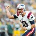 GREEN BAY, WISCONSIN - AUGUST 19: Mac Jones #10 of the New England Patriots celebrates after a touchdown in the first quarter against the Green Bay Packers during a preseason game at Lambeau Field on August 19, 2023 in Green Bay, Wisconsin.