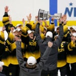Boston Pride players cheer as coach Paul Mara hoists the NWHL Isobel Cup trophy after the team's win over the Minnesota Whitecaps in the championship hockey game in Boston, Saturday, March 27, 2021. Organizers announced plans Friday, June 30, 2023, to launch a new women’s professional hockey league in January that they hope will provide a stable, economically sustainable home for the sport's top players for years to come. The agreement ends a long standoff between the seven-team Professional Hockey Federation (PHF) and the PWHPA.