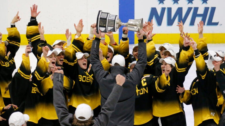 Boston Pride players cheer as coach Paul Mara hoists the NWHL Isobel Cup trophy after the team's win over the Minnesota Whitecaps in the championship hockey game in Boston, Saturday, March 27, 2021. Organizers announced plans Friday, June 30, 2023, to launch a new women’s professional hockey league in January that they hope will provide a stable, economically sustainable home for the sport's top players for years to come. The agreement ends a long standoff between the seven-team Professional Hockey Federation (PHF) and the PWHPA.