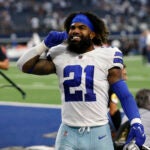 Dallas Cowboys running back Ezekiel Elliott gestures to the crowd as he leaves the field after an NFL football game against the Carolina Panthers in Arlington, Texas, Sunday, Oct. 3, 2021.