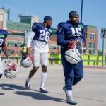 New England Patriots' Ezekiel Elliott along with J.J. Taylor (42) and Ameer Speed (28) walk to practice for NFL football training camp Wednesday, Aug. 16, 2023, in Green Bay, Wis.
