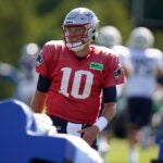 New England Patriots quarterback Mac Jones (10) warms up during an NFL football practice, Wednesday, Aug. 2, 2023, in Foxborough, Mass.