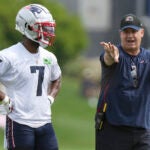 New England Patriots wide receiver JuJu Smith-Schuster (7) speaks with offensive coordinator Bill O'Brien, right, during an NFL football practice, Thursday, July 27, 2023, in Foxborough, Mass.