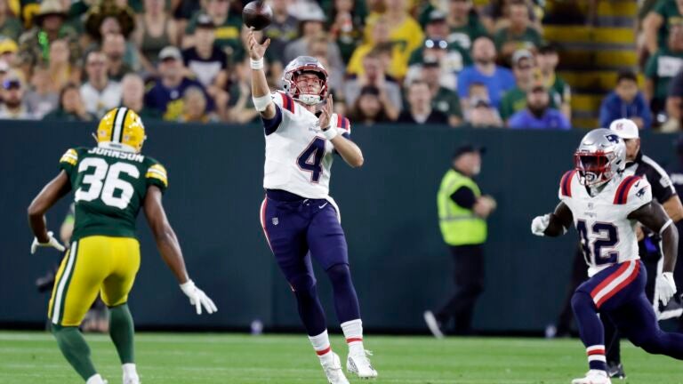 New England Patriots quarterback Bailey Zappe (4) against Green Bay Packers safety Anthony Johnson Jr. (36) during the first half of a preseason NFL football game, Saturday, August 19, 2023, in Green Bay , Wisconsin.