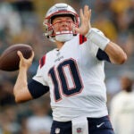 New England Patriots quarterback Mac Jones (10) practices before a preseason NFL football game against the Green Bay Packers Saturday, Aug. 19, 2023, in Green Bay, Wis.
