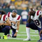 New England Patriots players react as teammate Isaiah Bolden is tended to after getting injured against the Green Bay Packers during the second half of a preseason NFL football game Saturday, Aug. 19, 2023, in Green Bay, Wis.
