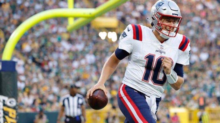 New England Patriots quarterback Mac Jones (10) reacts after a touchdown during the first half of a preseason NFL football game against the Green Bay Packers Saturday, Aug. 19, 2023, in Green Bay, Wis.