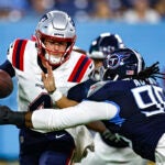 New England Patriots quarterback Bailey Zappe (4) has the ball stripped by Tennessee Titans defensive end Denico Autry (96) during their NFL football game Friday, Aug. 25, 2023, in Nashville, Tenn.