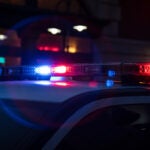 A stock photo of flashing blue and red lights on top of a police cruiser.