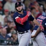 Boston Red Sox's Wilyer Abreu is congratulated by third base coach Carlos Febles (53) after hitting a two-run home run during the second inning of a baseball game against the Houston Astros, Thursday, Aug. 24, 2023, in Houston.