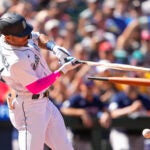 Seattle's Julio Rodriguez breaks his bat on an RBI single during the seventh inning.