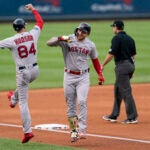 Alex Verdugo of the Red Sox, right, celebrates with third base coach Carlos Febles after hitting a home run against the Nationals during the first inning.