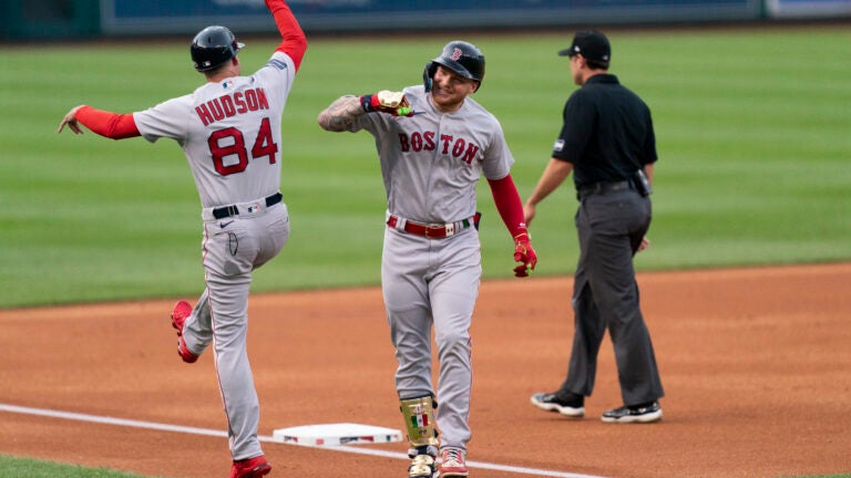 Alex Verdugo of the Red Sox, right, celebrates with third base coach Carlos Febles after hitting a home run against the Nationals during the first inning.