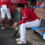 Los Angeles Angels' Shohei Ohtani sits in the dugout.