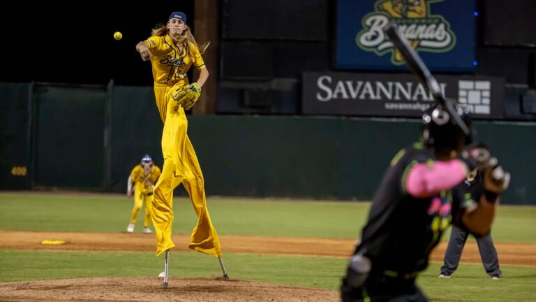 MAY 11: Dakota "Stilts" Albritton #14 of the Savannah Bananas pitches against the Party Animals at Grayson Stadium on May 11, 2023 in Savannah, Georgia. Albritton plays Banana Ball on Stilts. He plays the field, bats, and he pitches all while wearing a pair of stilts while playing.