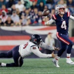 Houston Texans defensive tackle Roy Lopez, left, reaches for New England Patriots quarterback Bailey Zappe (4) during the first half of an NFL preseason football game Thursday, Aug. 10, 2023, in Foxborough, Mass.