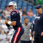 New England Patriots quarterback Mac Jones, left, sets to pass next to offensive coordinator Bill O'Brien, before the team's NFL preseason football game against the Houston Texans on Thursday, Aug. 10, 2023, in Foxborough, Mass.