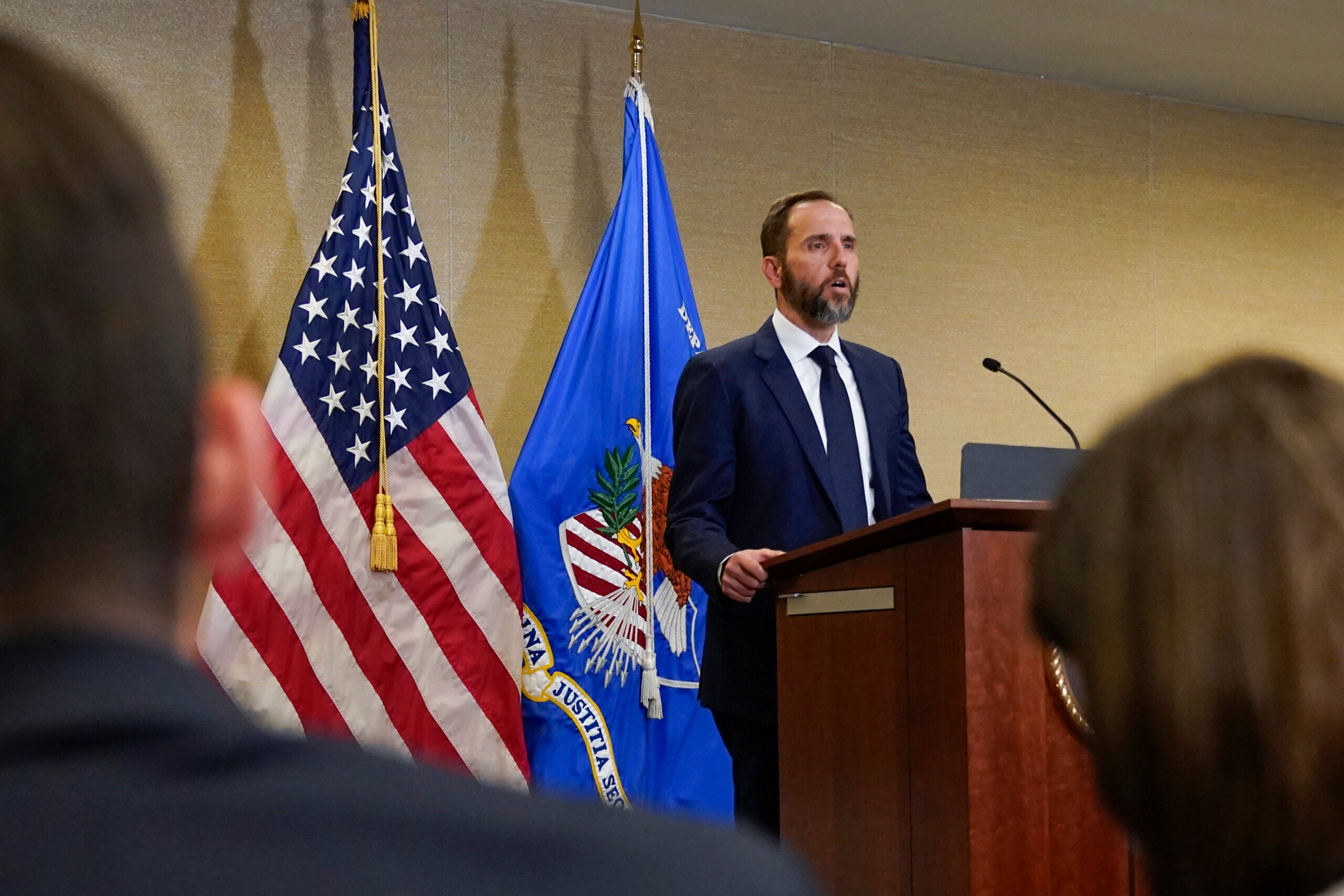 Special counsel Jack Smith speaks at a podium.