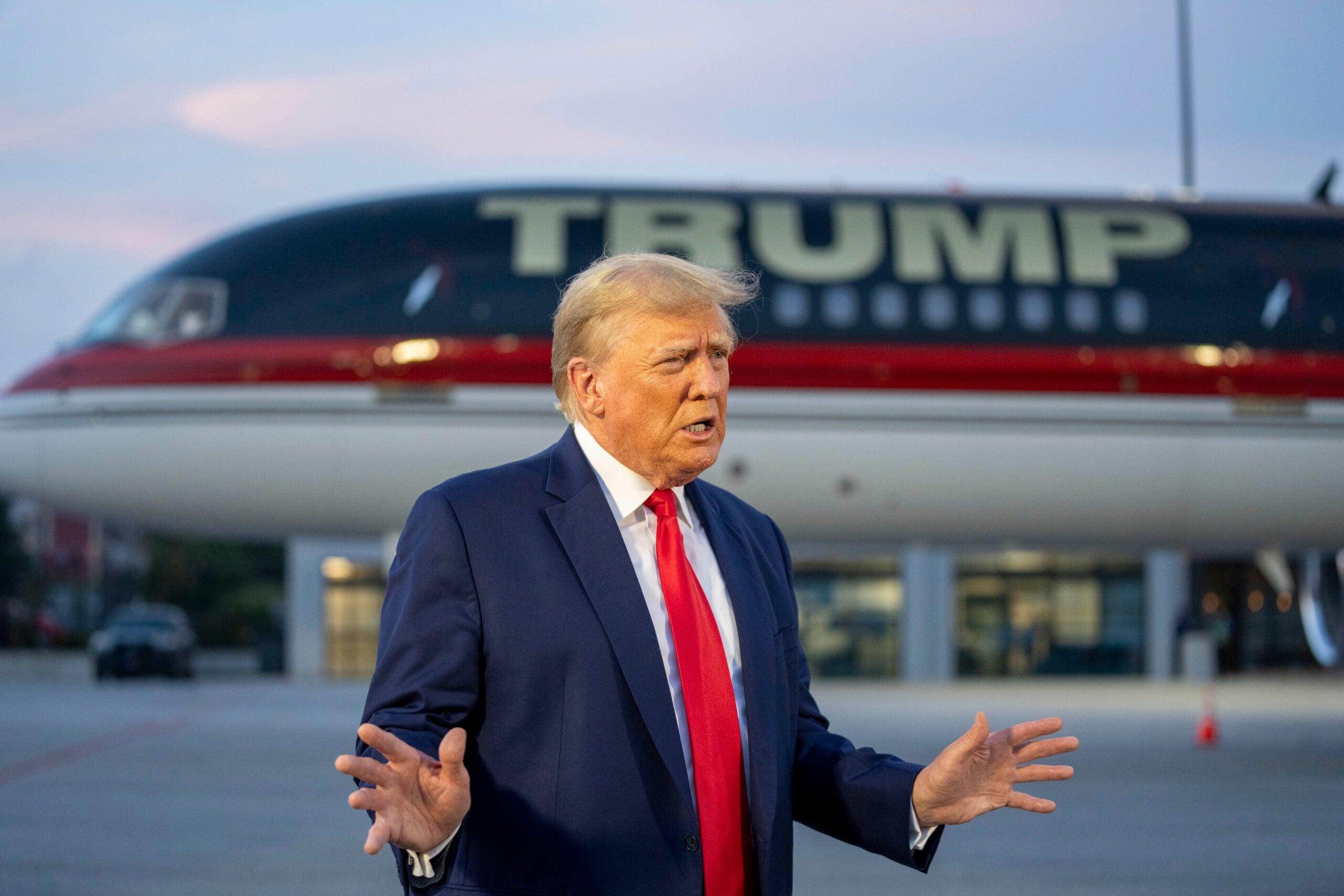 Former President Donald Trump speaks with reporters before departure from Hartsfield-Jackson Atlanta International Airport, Thursday, Aug. 24, 2023, in Atlanta.