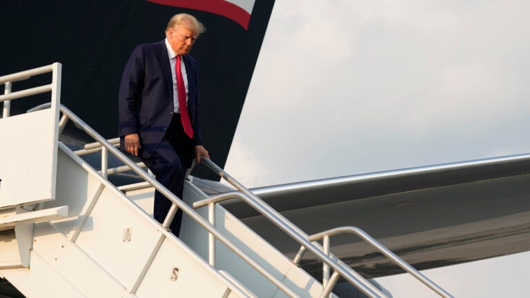 Former President Donald Trump steps off his plane as he arrives at Hartsfield-Jackson Atlanta International Airport, Thursday, Aug. 24, 2023, in Atlanta.