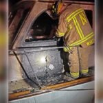 A firefighter surveys damage to a 42-foot Wesmac Trawler.