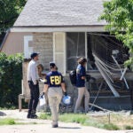 Law enforcement investigate the scene of a shooting involving the FBI Wednesday, Aug. 9, 2023 in Provo, Utah. A man accused of making threats against President Joe Biden was shot and killed by FBI agents hours before the president was expected to land in the state Wednesday, authorities said.
