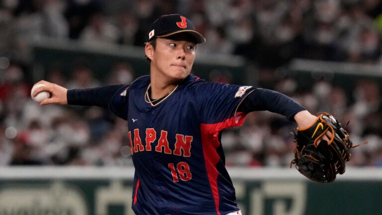 Yoshinobu Yamamoto of Japan heads to Australia to win the first inning in their Pool B match at the World Baseball Classic at the Tokyo Dome on Sunday, March 12, 2023, in Tokyo.