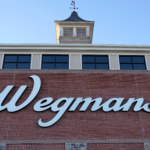 The front of a Wegmans grocery store with a "Wegmans" sign