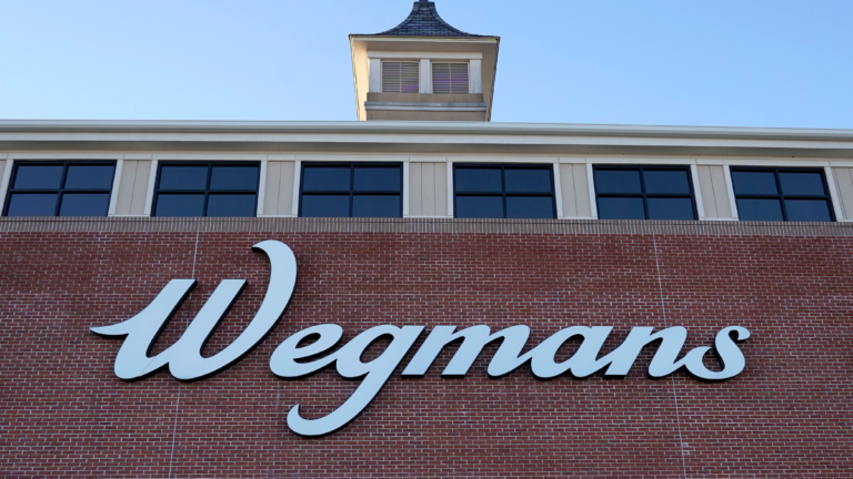 The front of a Wegmans grocery store with a "Wegmans" sign