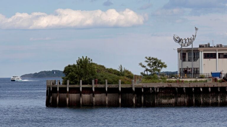 A metal codfish sculpture sits above the roof of the former Legal Sea Foods plant, which has been sold to Stavis Seafoods.