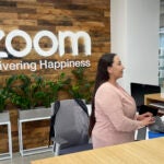 A woman works at Zoom headquarters.
