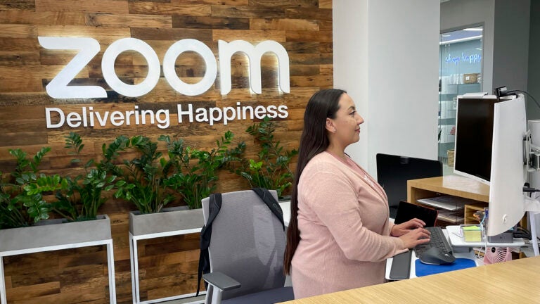 A woman works at Zoom headquarters.