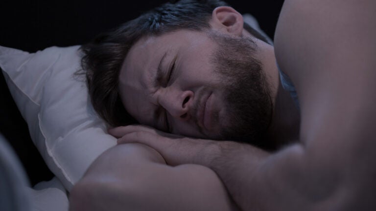 A man struggles to sleep.