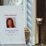 A poster featuring a photo of Ersilia Cataldo Matarazzo is displayed at a service at St. Anthony's Parish in Everett in 2018.