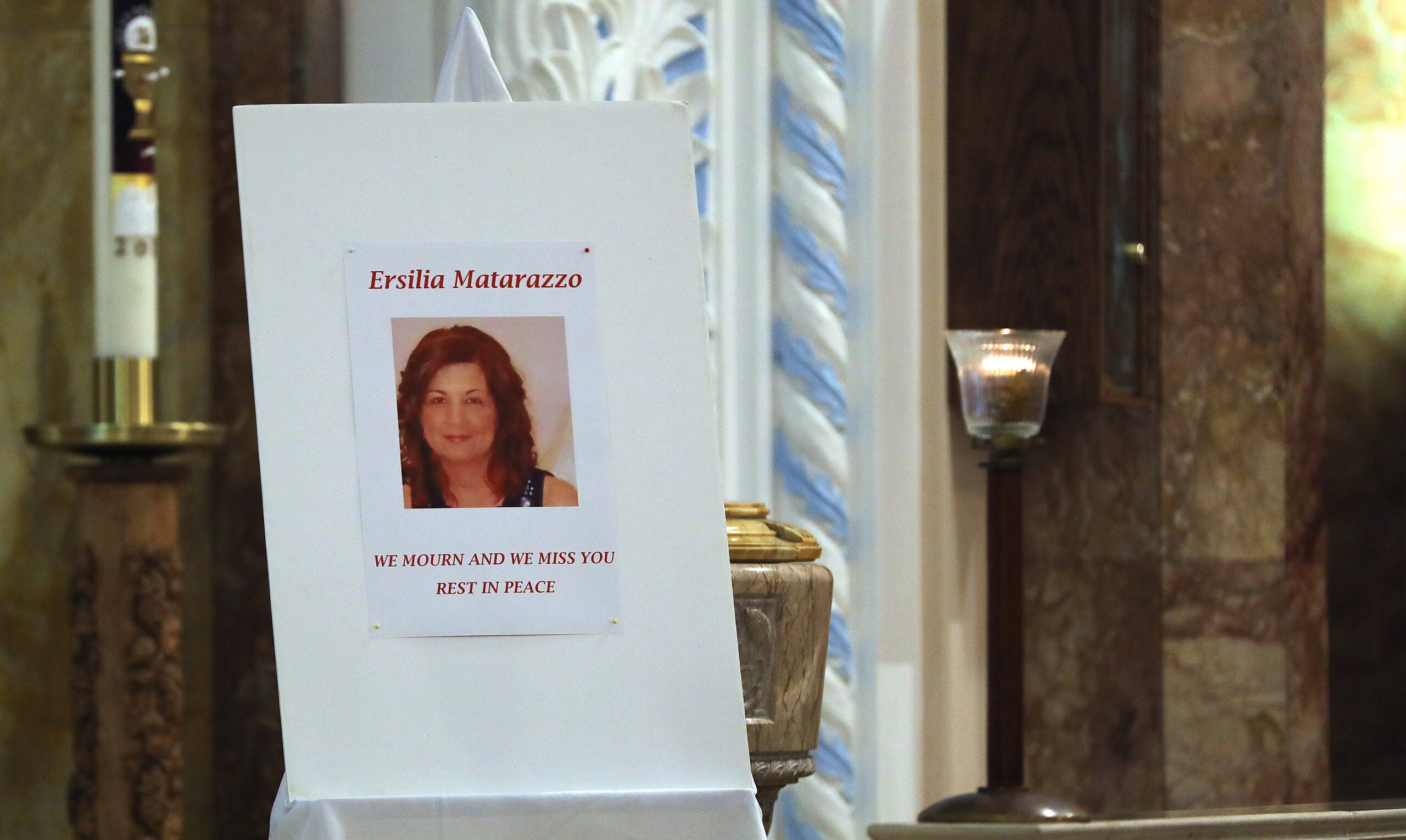 A poster featuring a photo of Ersilia Cataldo Matarazzo is displayed at a service at St. Anthony's Parish in Everett in 2018.