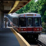 A Red Line subway, part of the Massachusetts Bay Transportation Authority, moves toward a subway platform.