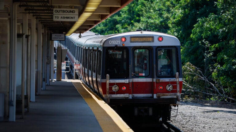 A Red Line subway, part of the Massachusetts Bay Transportation Authority, moves toward a subway platform.