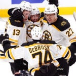 Bruins left wing Brad Marchand (63) and teammates celebrate Coyle’s goal for a 2-0 lead during the second period.